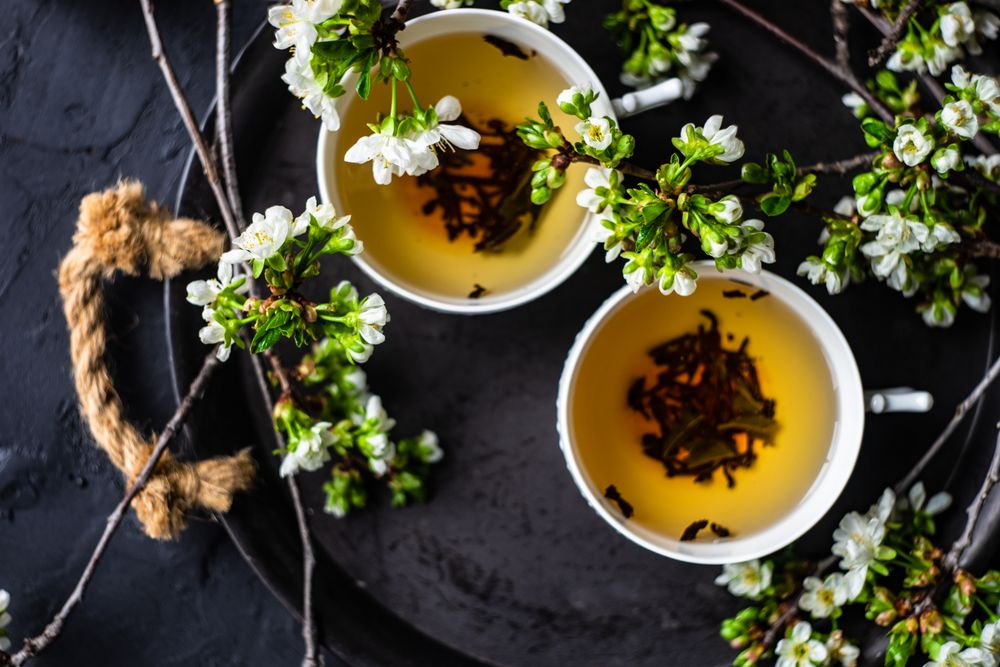 Tea time concept of loose leaf tea in cups with buds