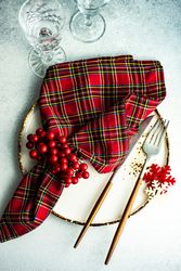 Tartan napkin with holly on Christmas table setting