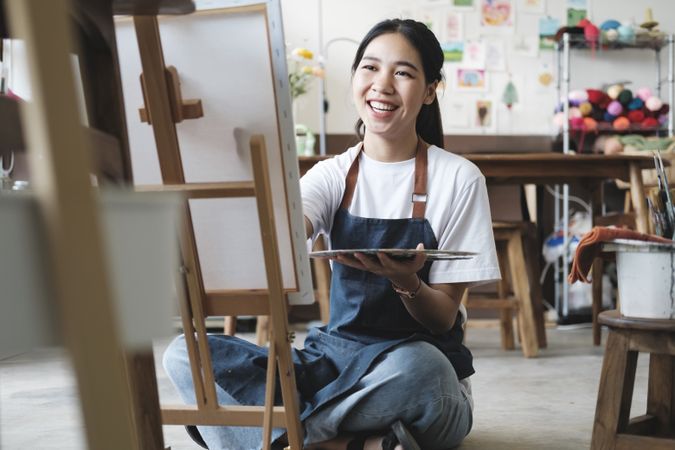 Crafting Inspiration. Female Artist Sketching and Painting in Workshop