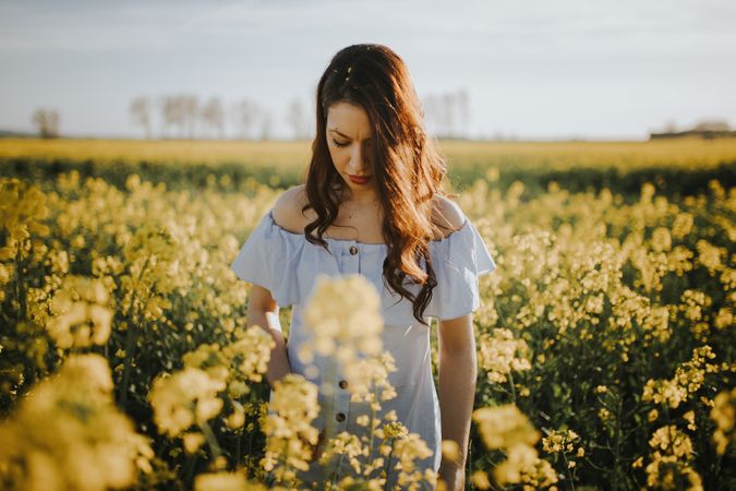 Woman with flowers in field