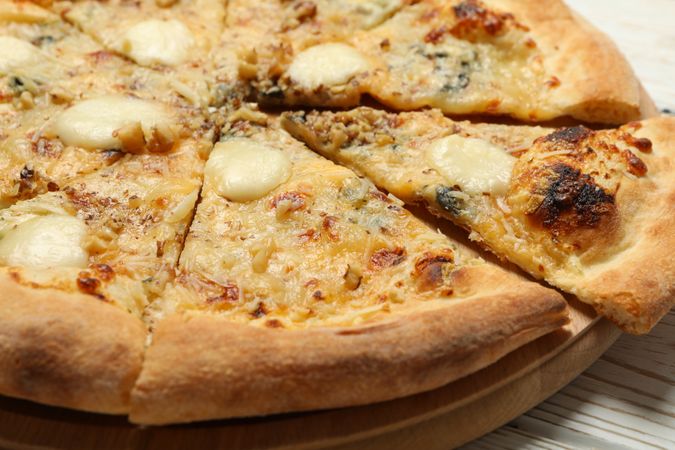 Cheese pizza on wooden background, close up