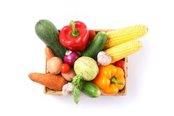 Wicker basket with vegetables isolated on plain background