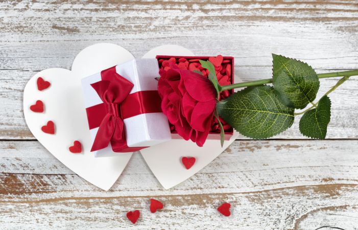 Valentine’s card with open gift box and single red rose