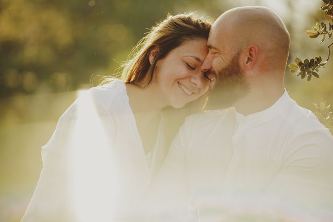 Tender couple embracing while standing at rural field
