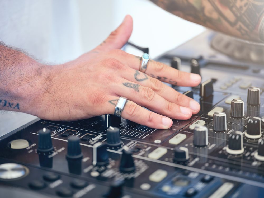 Crop man using professional DJ equipment