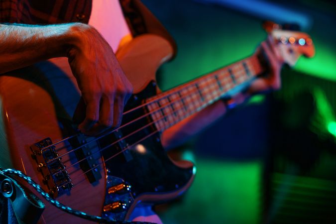 Bass Player In Stage With Colorful Lights