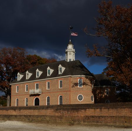 Red brick building with American flag, Colonial Williamsburg, Virginia