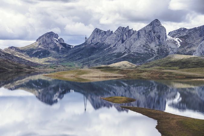 Cloudy sky over calm lake and mountains