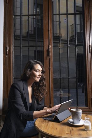 Young female using digital tablet in cafe