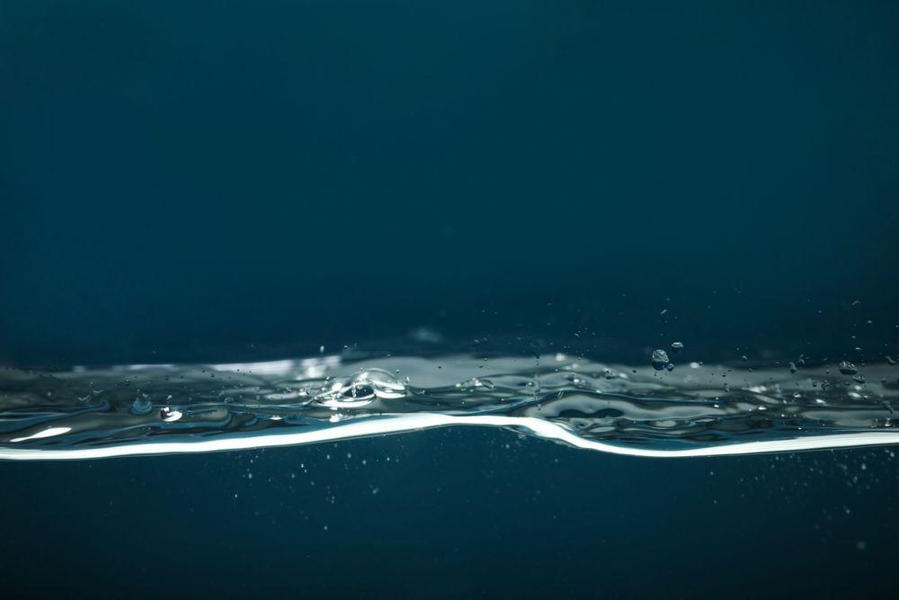 Side view of wave on dark background