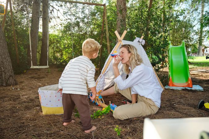 Mother and son playing with toys in park