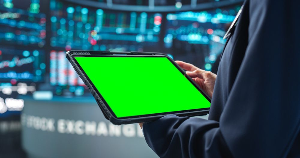 Person Holding a Tablet Computer with Green Screen Mock Up Display.