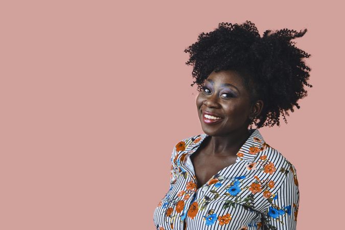 Studio shot of Black woman with a happy and confident expression