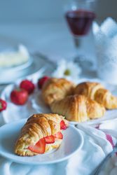 Fruit filled croissant on tablecloth
