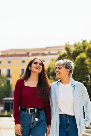 two young women walking in a park