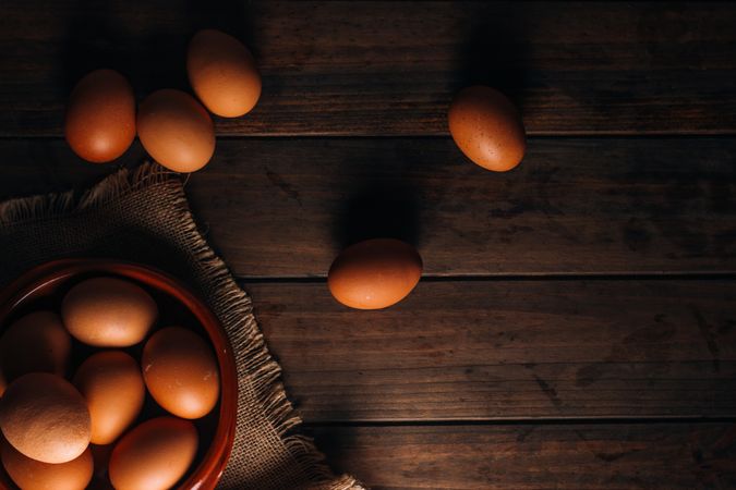 Chicken eggs on napkin on wooden table