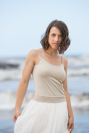 Charming young woman on shore near water