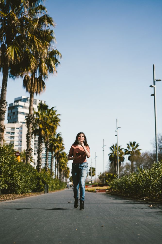 Teen girl walking happily through the streets.
