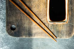 Top view of Asian table setting with chopsticks and soy sauce