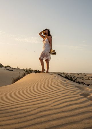 Active woman walking in dry desert barefoot