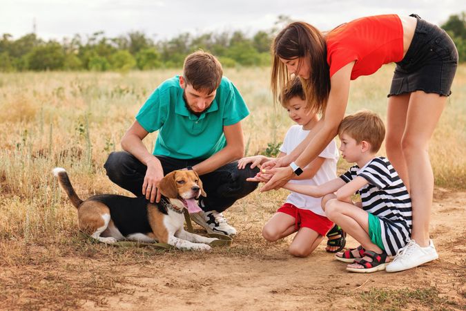 Family walk and training dog