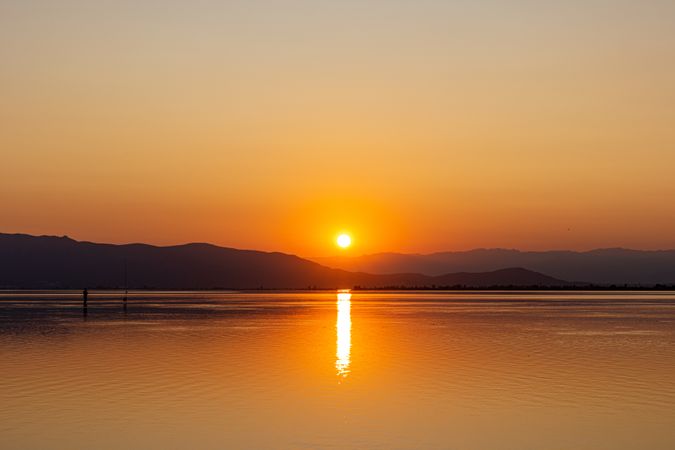 Sunset over picturesque hills and sea