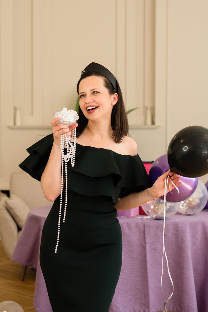 Woman holding jewelry and balloons