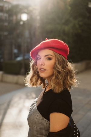 Stylish female in beret looking at camera