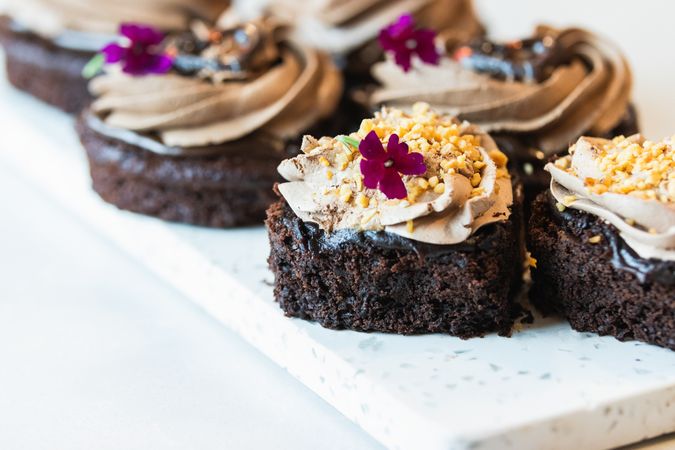 Sweet sponge cakes with whipped cream on table