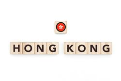 Wooden blocks bearing the name and flag of Hong Kong. HongKonger and Asian Culture, national identity, travel, and geography in a copy space design.
