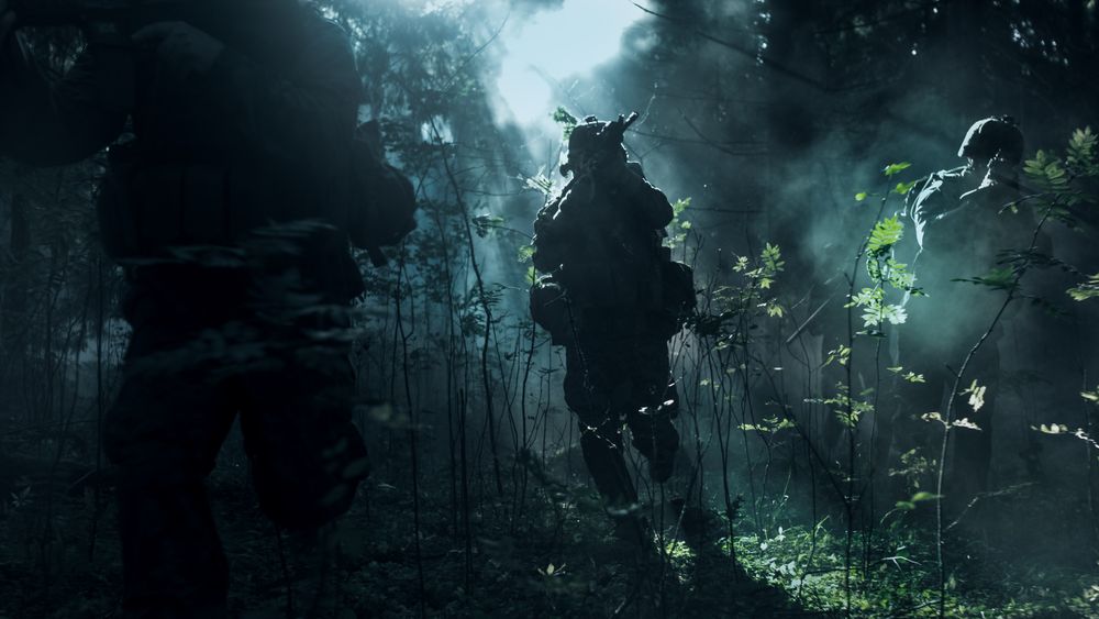 Fully Equipped Soldiers Wearing Camouflage Uniform Attacking Enemy, Rifles Ready to Shoot.