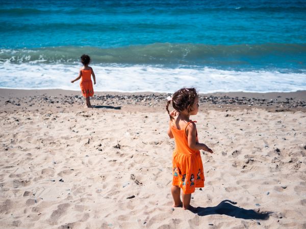 Little girls standing on beach and admiring view