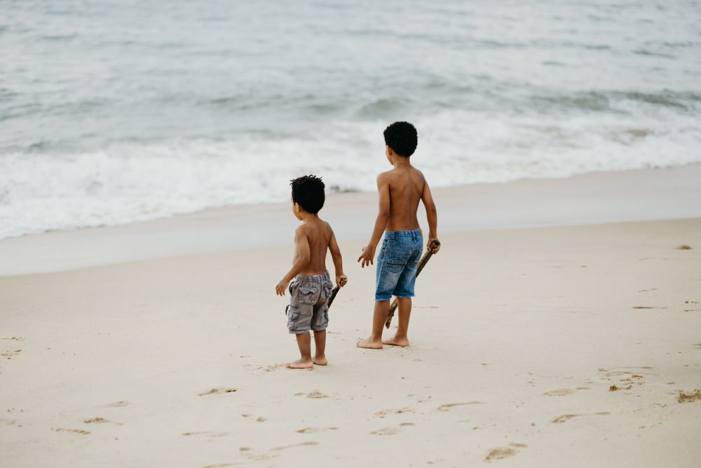 Black boys playing on beach