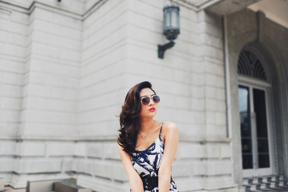 Woman in dark and light dress wearing sunglasses