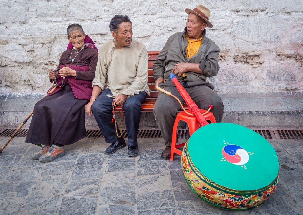Tibet - August, 29 2014: people sitting on street bench
