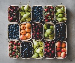 Rows fresh fruit arranged together in eco-friendly boxed