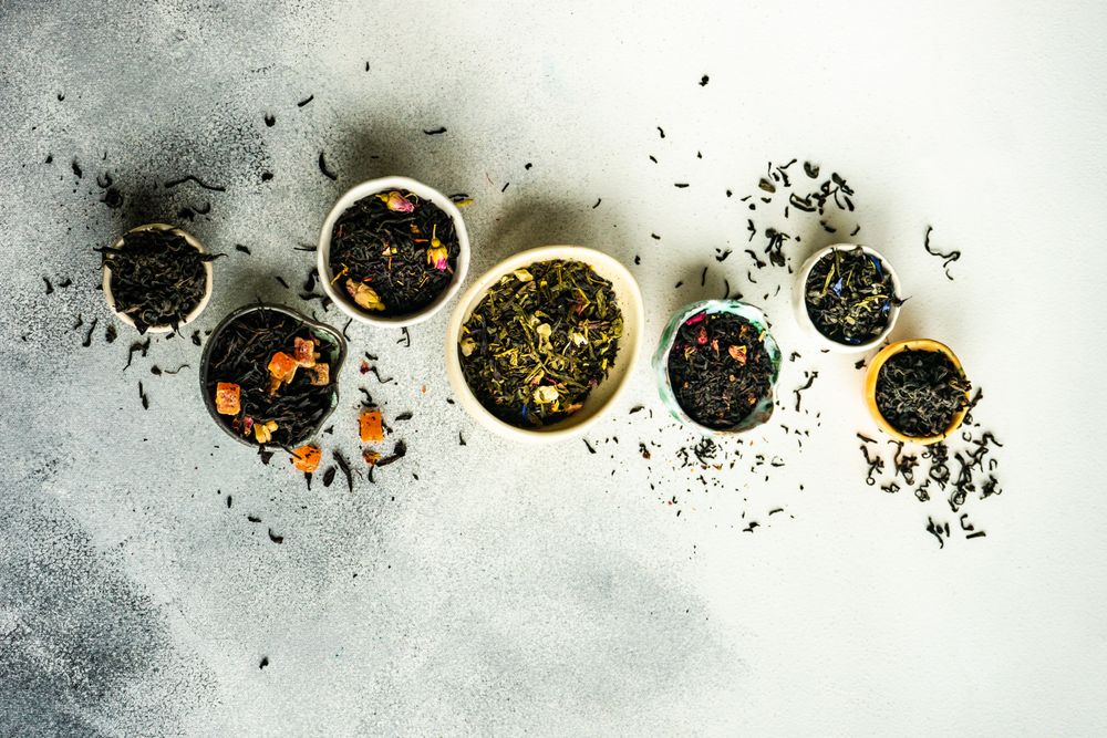 Top view of tea varieties on stone background