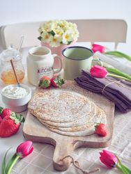 Delicious pancakes with berries and chocolate on table