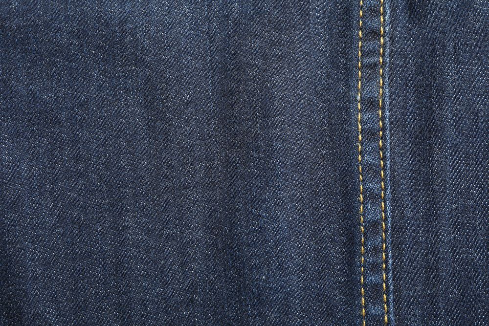 Texture of blue jeans as background, space for text