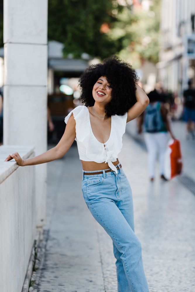 female leaning in concrete parapet
