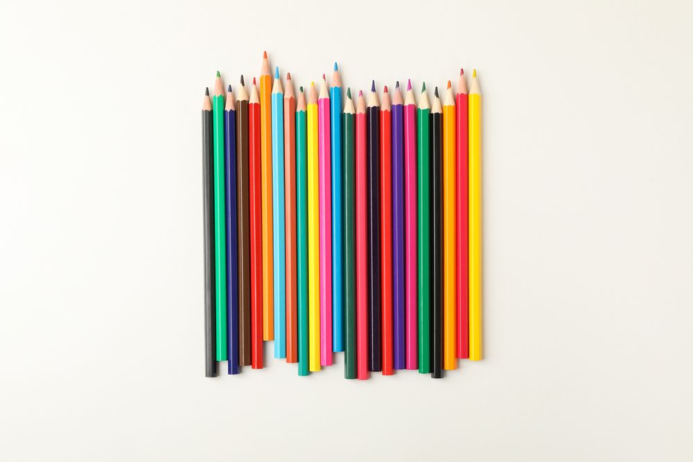 Colorful pencils on blank background, top view