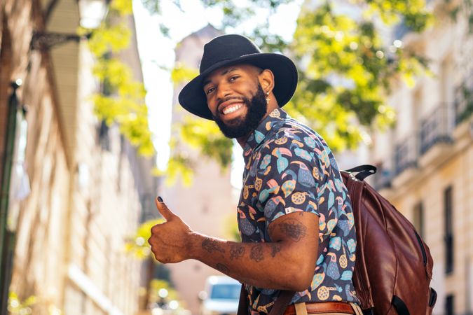 Stylish Black man walking on the city street