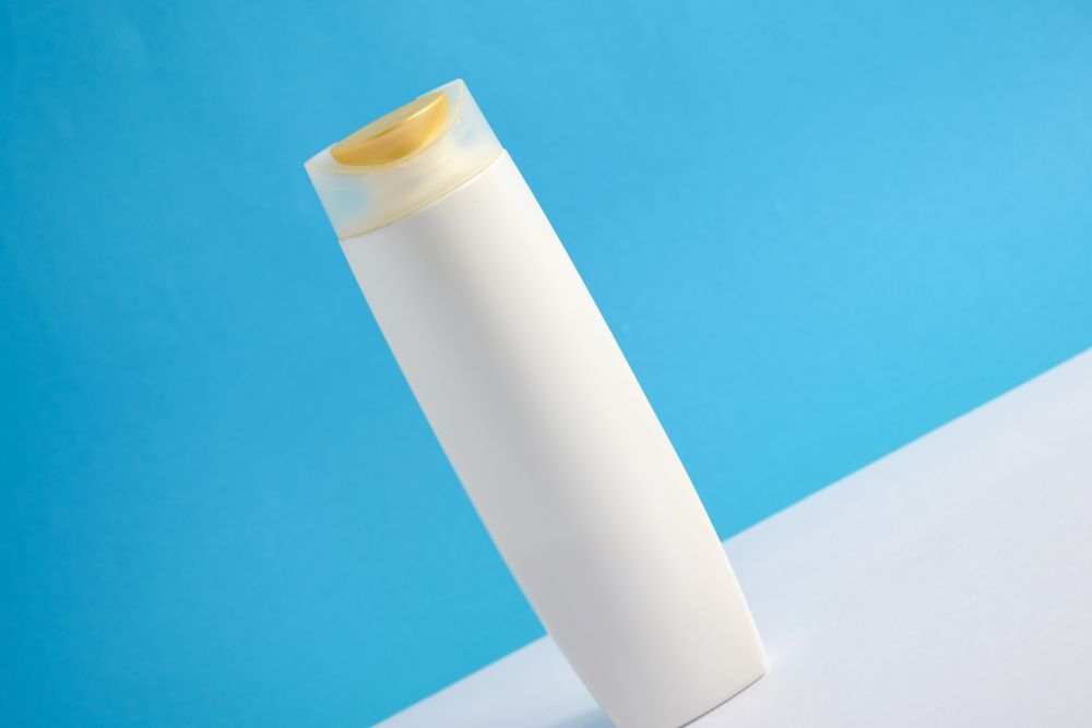 Blank body wash bottle diagonally set up in blue room