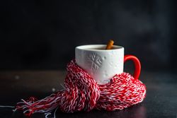 Side view of mug wrapped in red woolen scarf