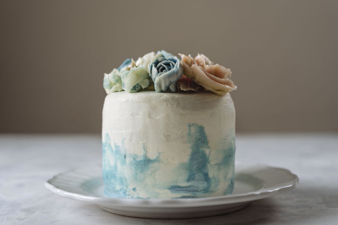 Buttercream flowers cake, blue and pastel peach colors