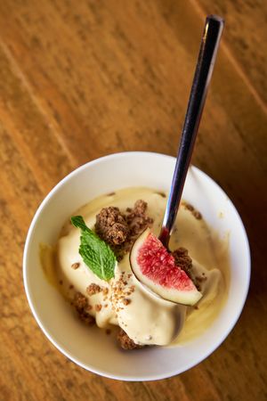 Aerial photo of a spoon pinned in a dish of prickly pear mousse