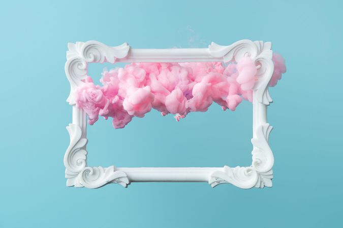 Cloud-like pink color paint with  picture frame on blue background
