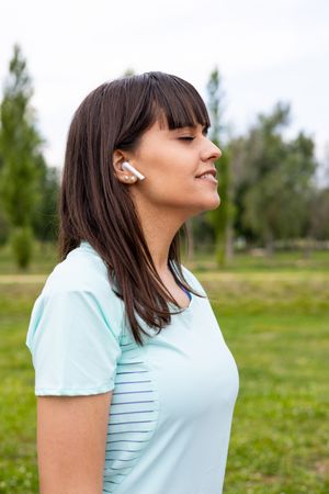 Runner woman relaxed listening to music for training outdoors