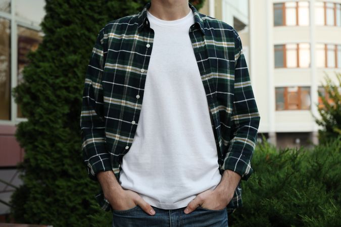 Men in blank t-shirt and green checkered shirt, space for text