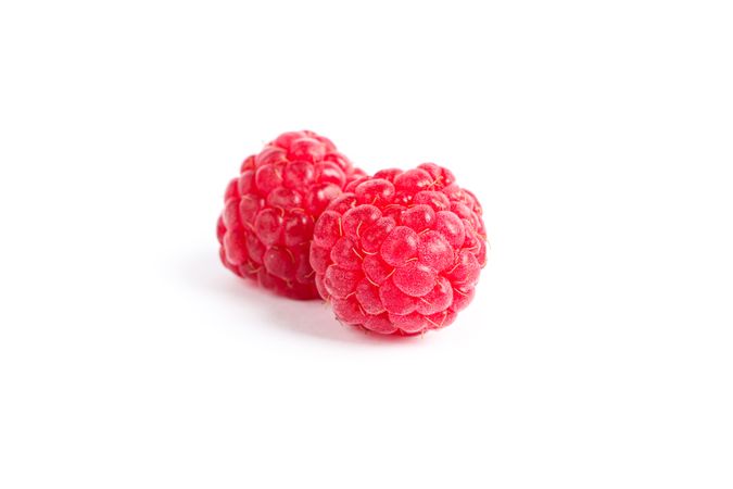 Fresh sweet raspberries isolated on blank background
